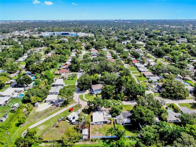 an aerial view of a houses with a yard