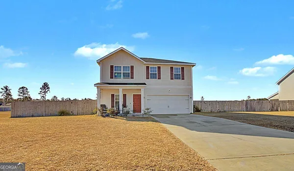 a view of a house with a yard