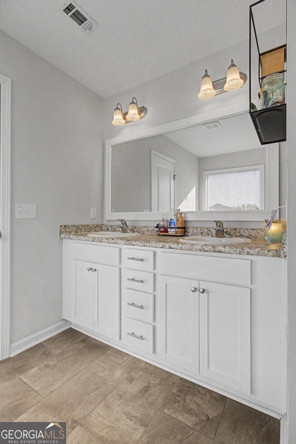 263 Brandonwood Road Northeast Ludowici, GA 31316 - Photo 14 of 34 a bathroom with a granite countertop sink and a mirror