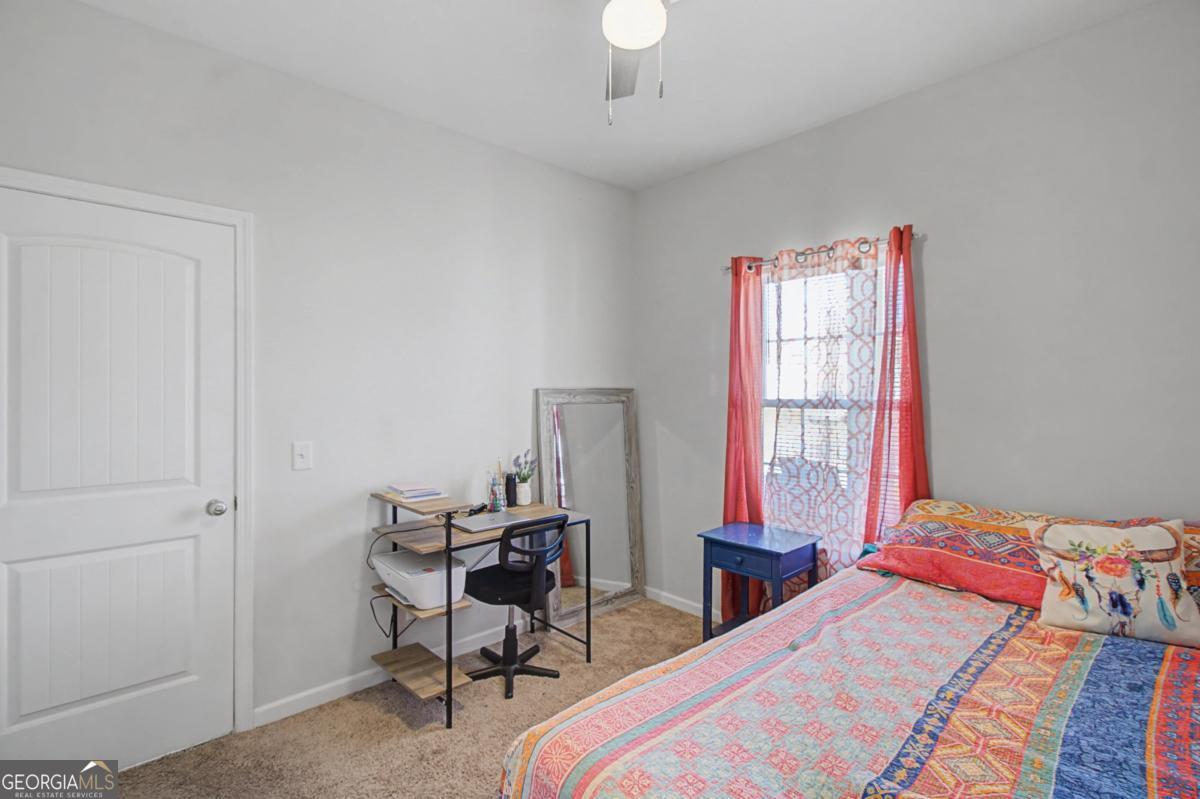 263 Brandonwood Road Northeast Ludowici, GA 31316 - Photo 19 of 34 a bedroom with a bed and a window