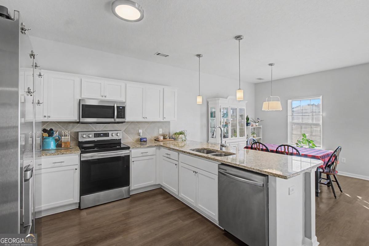 263 Brandonwood Road Northeast Ludowici, GA 31316 - Photo 2 of 34 a kitchen with a sink stove and microwave