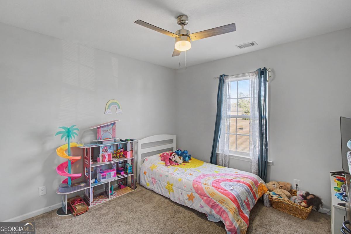 263 Brandonwood Road Northeast Ludowici, GA 31316 - Photo 21 of 34 a bedroom with a bed and a window