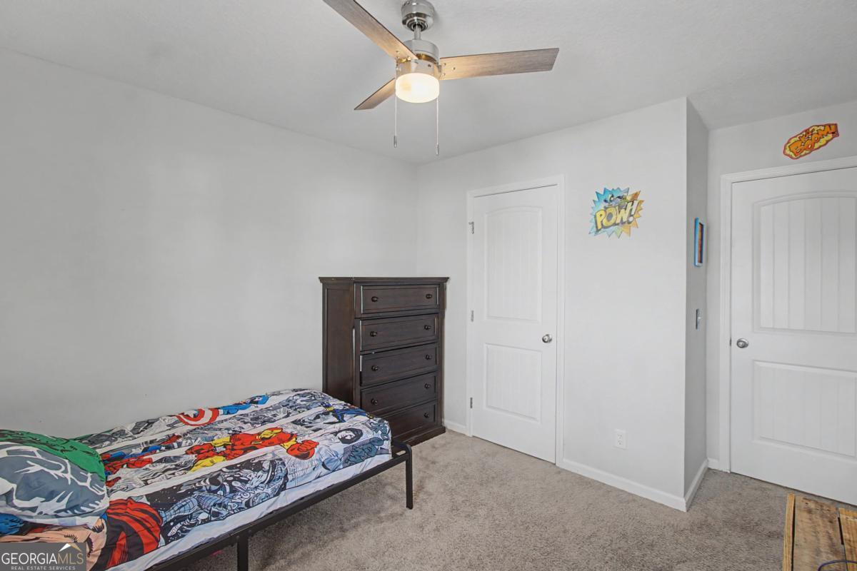 263 Brandonwood Road Northeast Ludowici, GA 31316 - Photo 24 of 34 a bedroom with a bed and a dresser