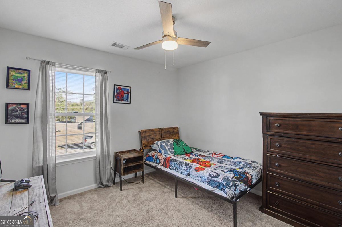 263 Brandonwood Road Northeast Ludowici, GA 31316 - Photo 25 of 34 a bedroom with a bed and a window