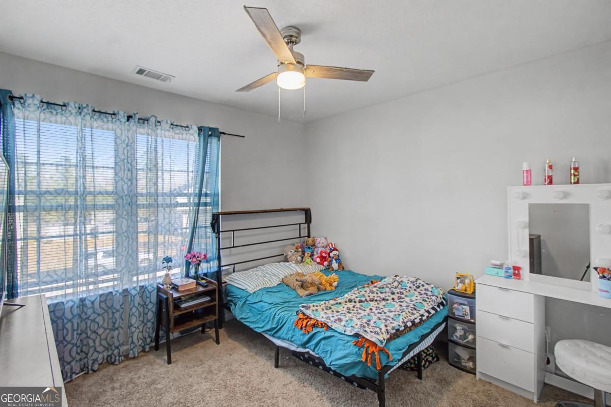 263 Brandonwood Road Northeast Ludowici, GA 31316 - Photo 26 of 34 a bedroom with a bed and a window