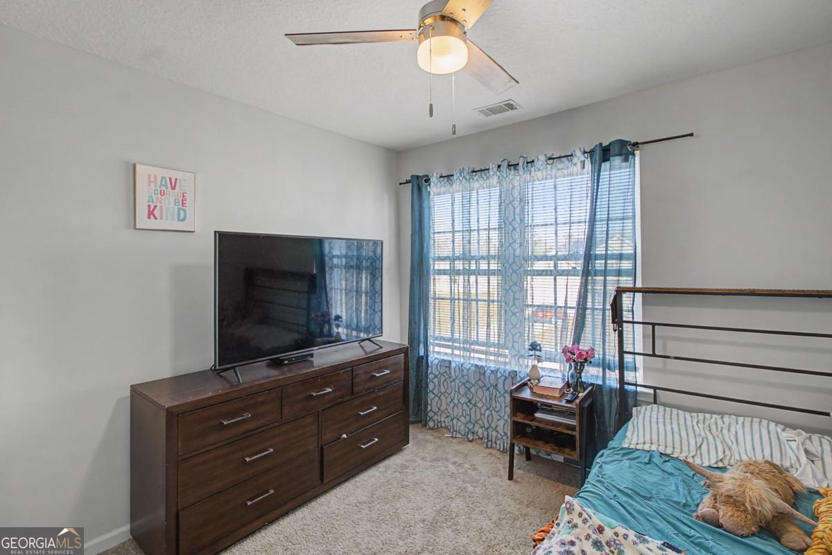 263 Brandonwood Road Northeast Ludowici, GA 31316 - Photo 28 of 34 a living room with furniture and a flat screen tv