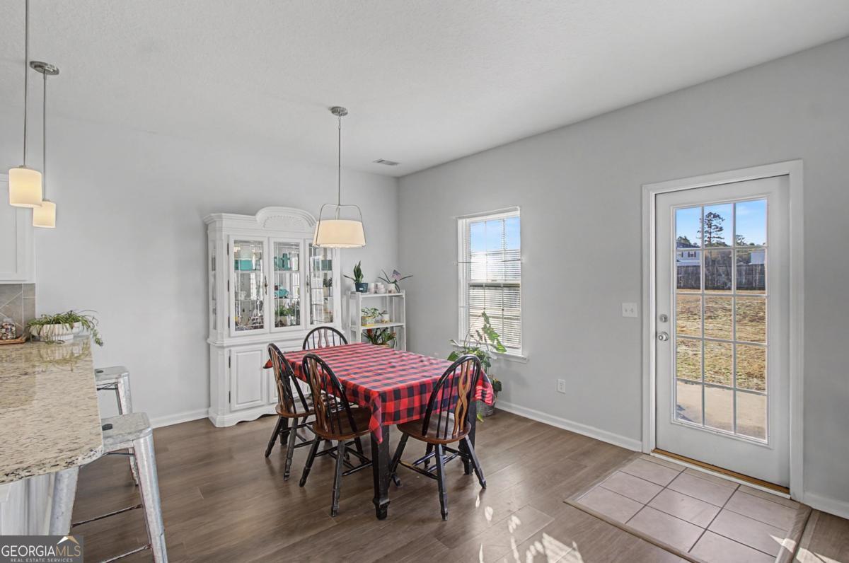 263 Brandonwood Road Northeast Ludowici, GA 31316 - Photo 4 of 34 a dining room with furniture a chandelier and wooden floor