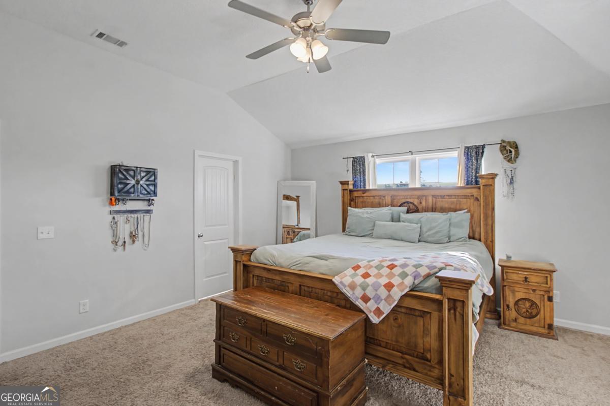 263 Brandonwood Road Northeast Ludowici, GA 31316 - Photo 10 of 34 a bedroom with a bed and ceiling fan