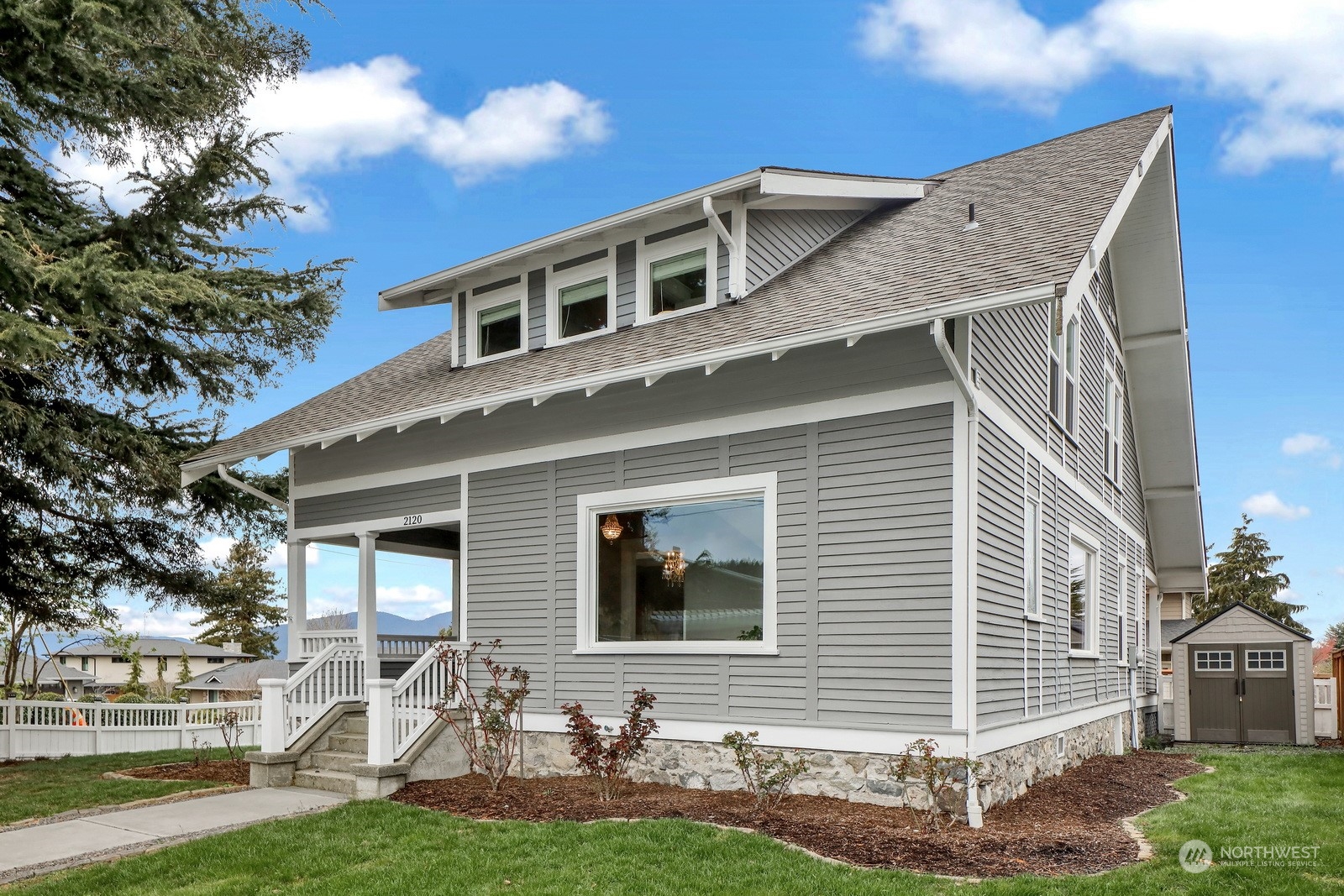 2120 12th Street Anacortes, WA 98221 - Photo 1 of 40 a front view of a house with a yard