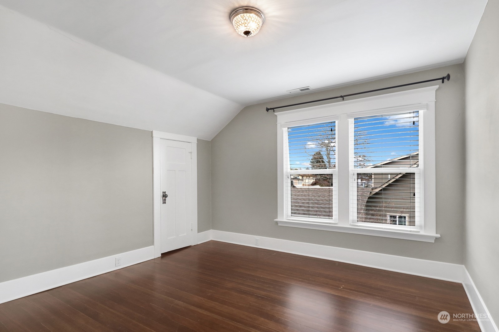 2120 12th Street Anacortes, WA 98221 - Photo 22 of 40 a view of an empty room with wooden floor and a window