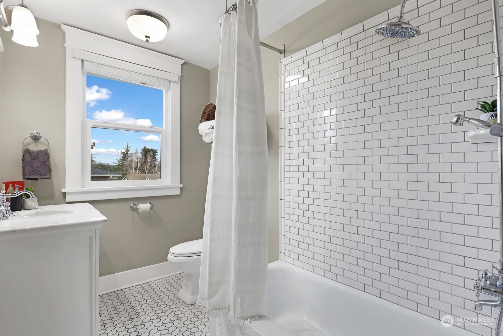 2120 12th Street Anacortes, WA 98221 - Photo 23 of 40 a bathroom with a sink a toilet a window and tub