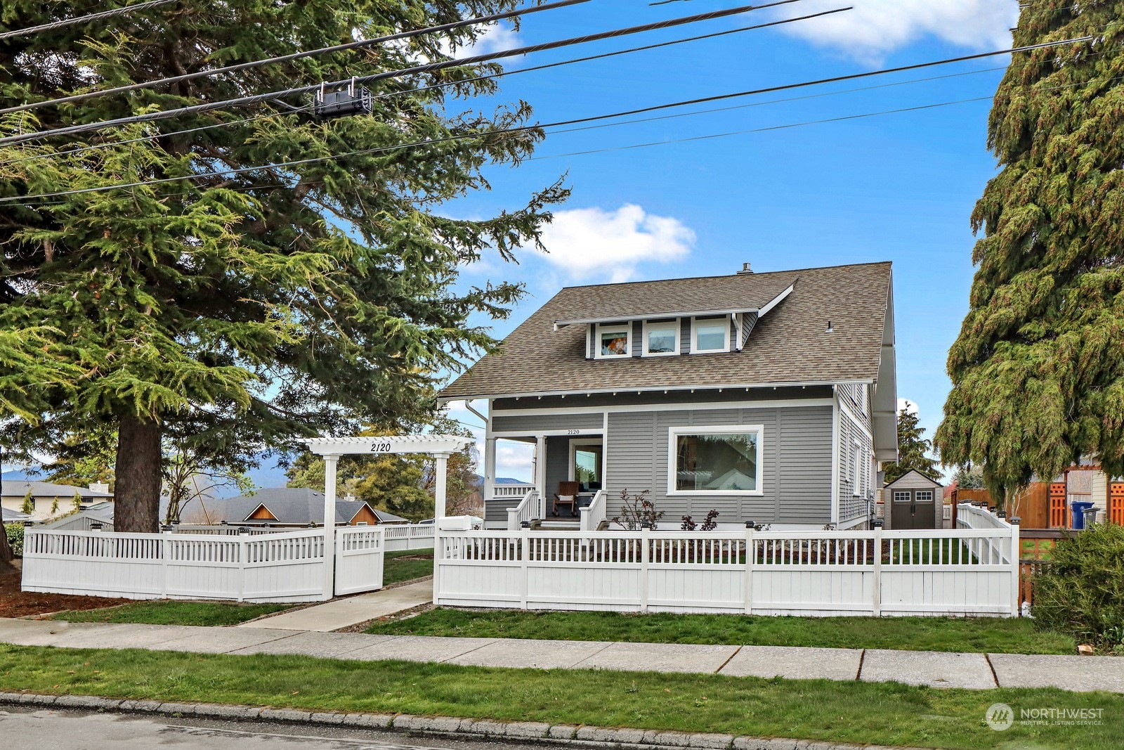 2120 12th Street Anacortes, WA 98221 - Photo 32 of 40 a front view of a house with a yard table and chairs