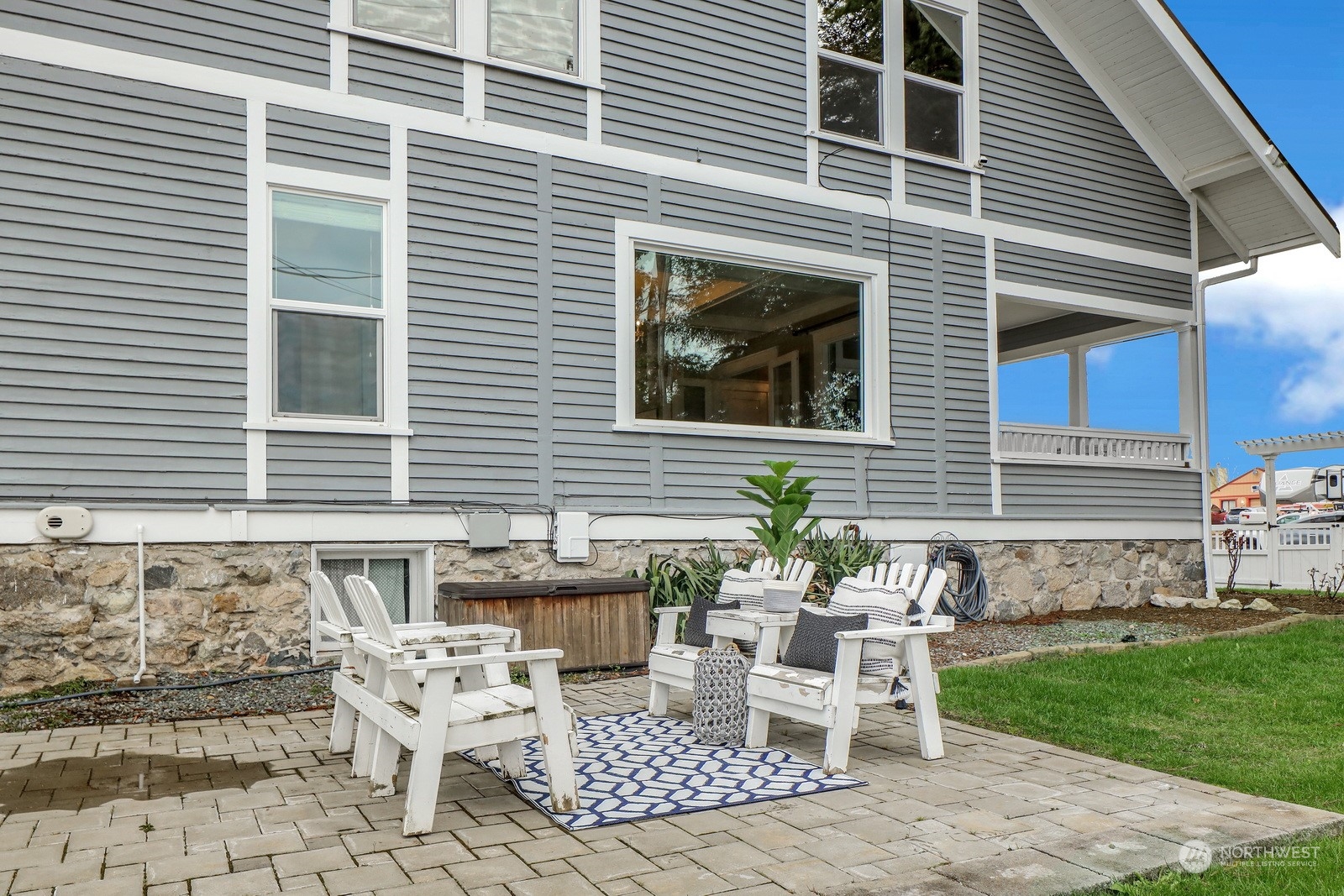2120 12th Street Anacortes, WA 98221 - Photo 35 of 40 a view of a chairs and table in back yard of the house