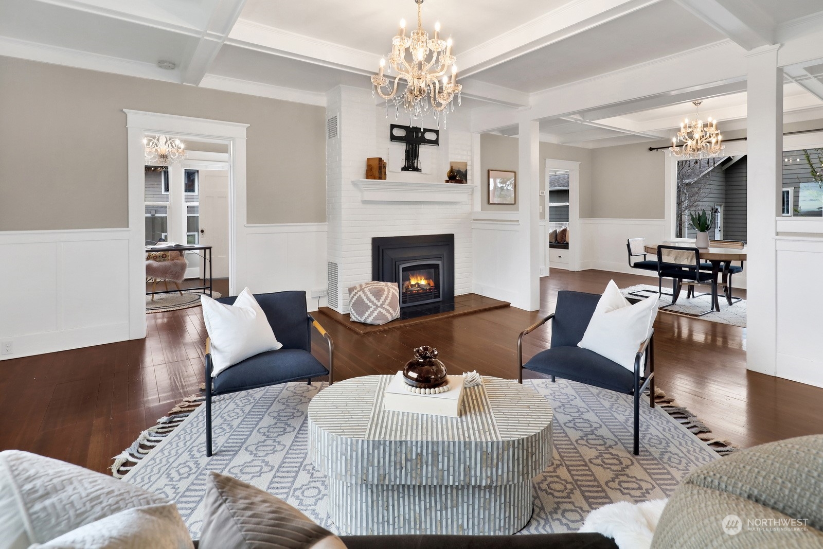 2120 12th Street Anacortes, WA 98221 - Photo 5 of 40 a living room with furniture a fireplace and a chandelier