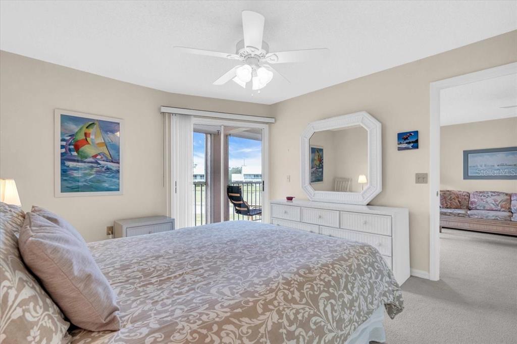 6505 Stone River Road, Unit 202 Bradenton, FL 34203 - Photo 25 of 55 a bedroom with a large bed and a chandelier