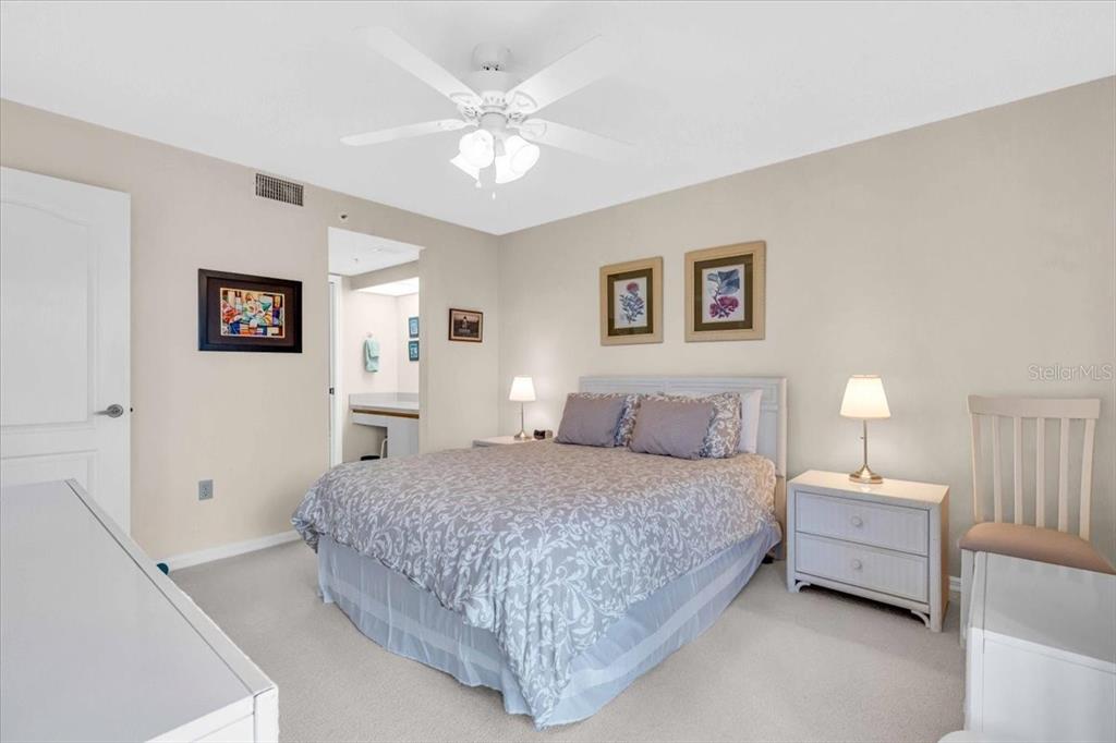 6505 Stone River Road, Unit 202 Bradenton, FL 34203 - Photo 26 of 55 a bedroom with a large bed and a chandelier