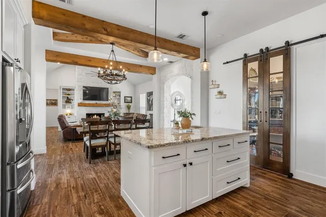 a kitchen with sink cabinets and dining table