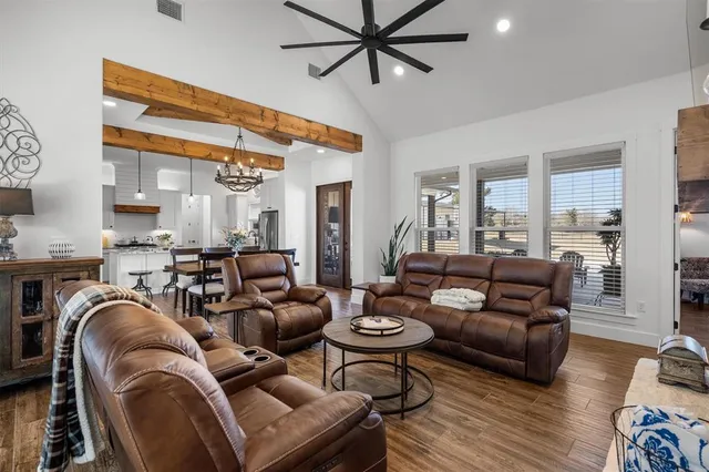 a living room with furniture and a view of kitchen