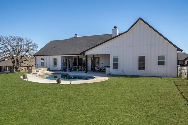 a front view of a house with swimming pool having outdoor seating