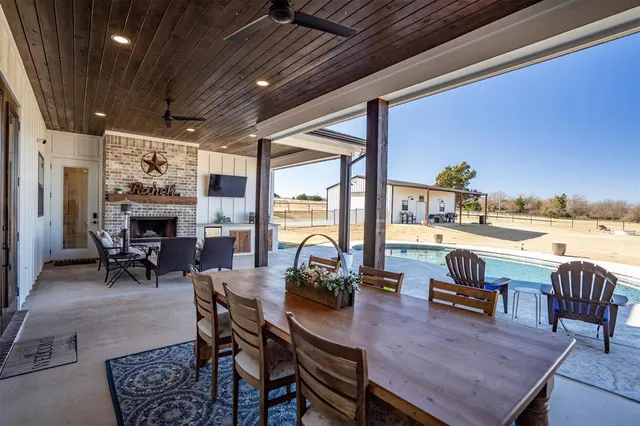 a living room with furniture a flat screen tv and a large window