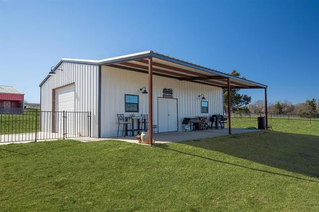 a backyard of a house with table and chairs