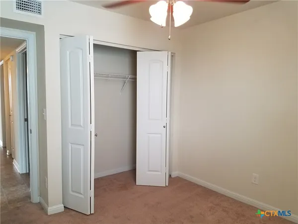 a view of a chandelier fan in a room