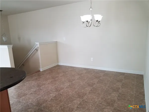 a kitchen with granite countertop white cabinets and stainless steel appliances