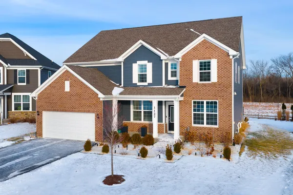 a front view of a house with a yard