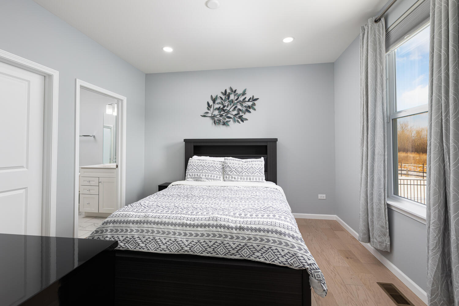 1127 Hibbard Road Naperville, IL 60563 - Photo 22 of 84 a bedroom with a large bed and a chandelier