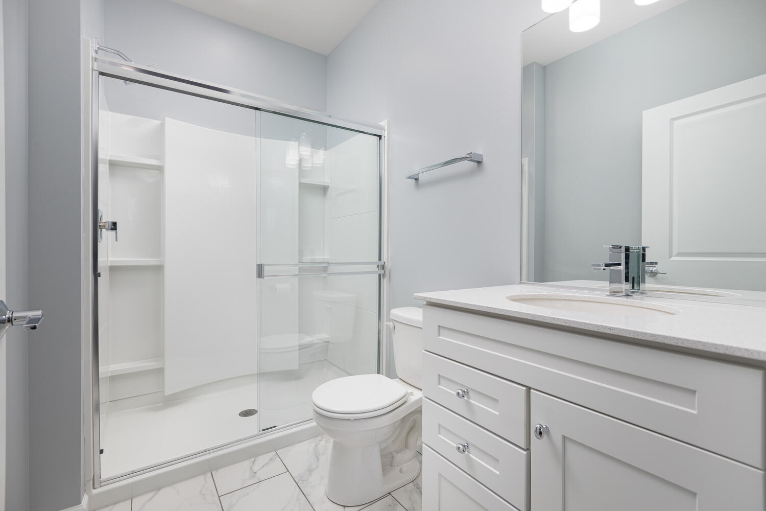 1127 Hibbard Road Naperville, IL 60563 - Photo 23 of 84 a bathroom with a shower sink vanity mirror and toilet