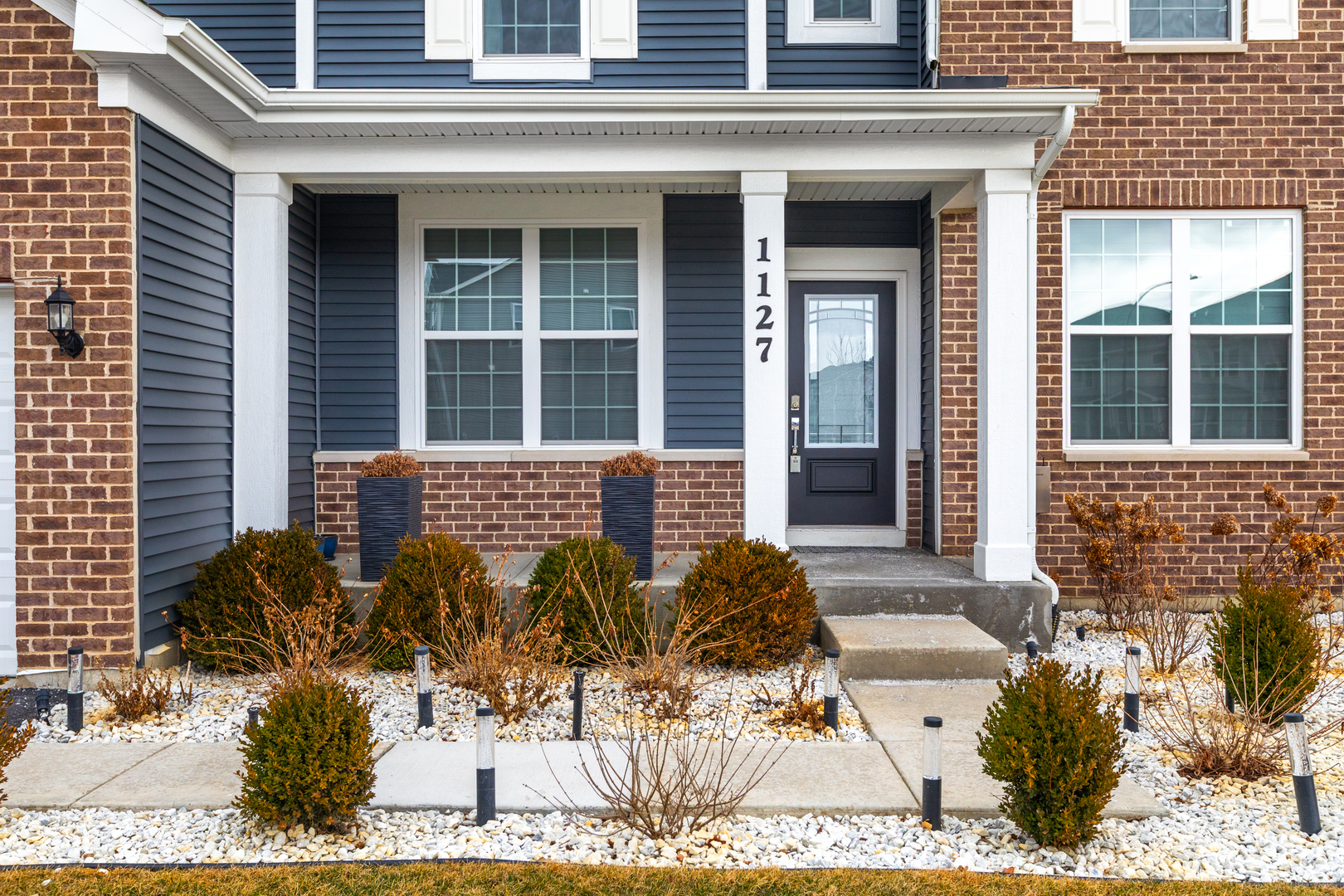 1127 Hibbard Road Naperville, IL 60563 - Photo 68 of 84 front view of a brick house with potted plants