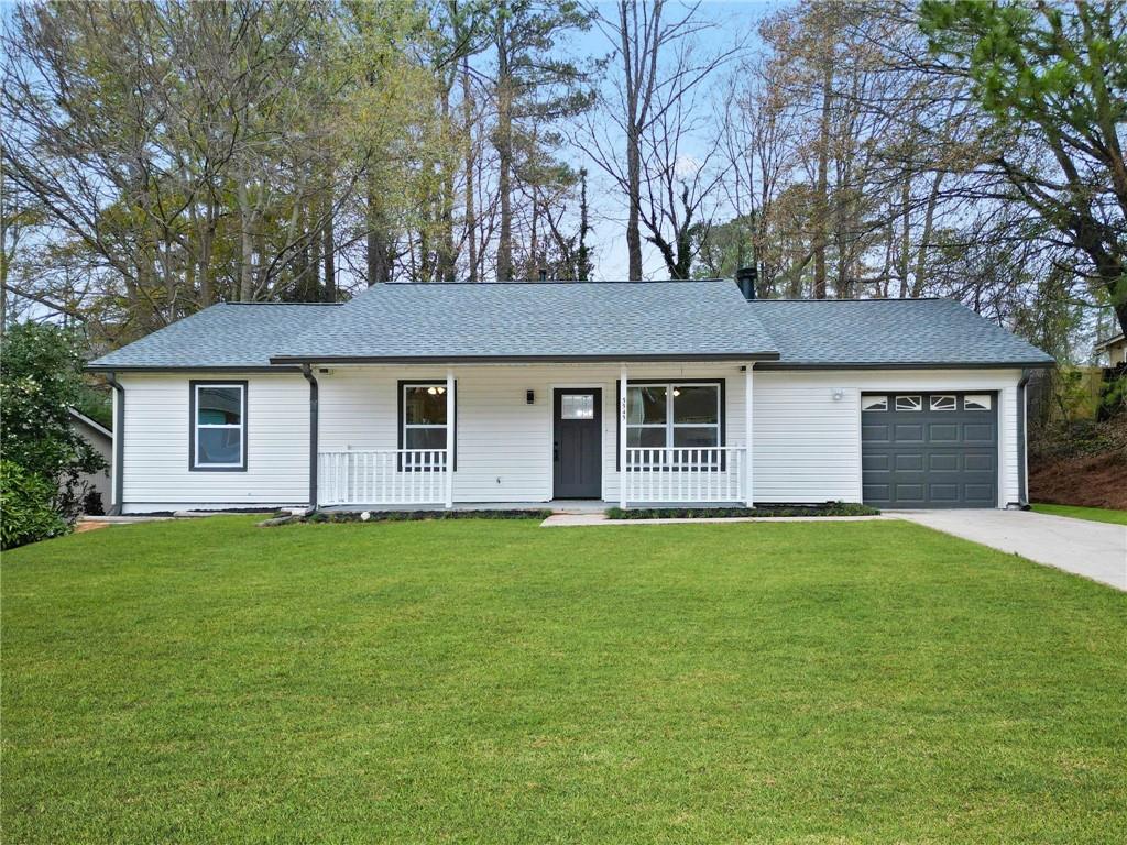 5545 Weatherford Road Norcross, GA 30093 - Photo 1 of 1 Single story home with a garage, a front yard, and a porch