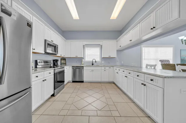 a bed room with a bed and a chandelier