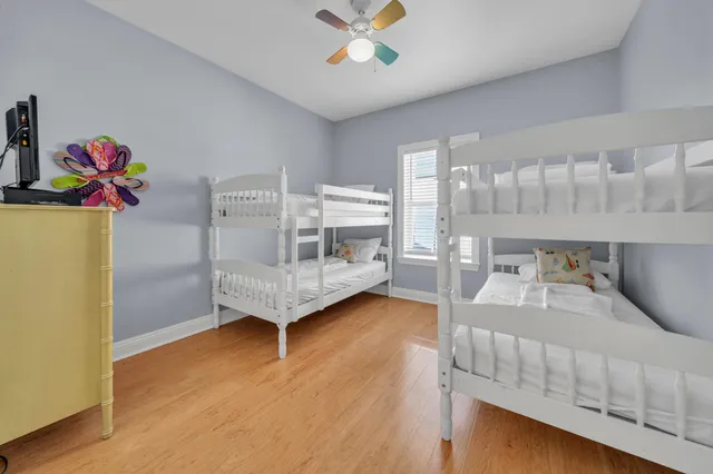 a spacious bedroom with a large bed and a chandelier