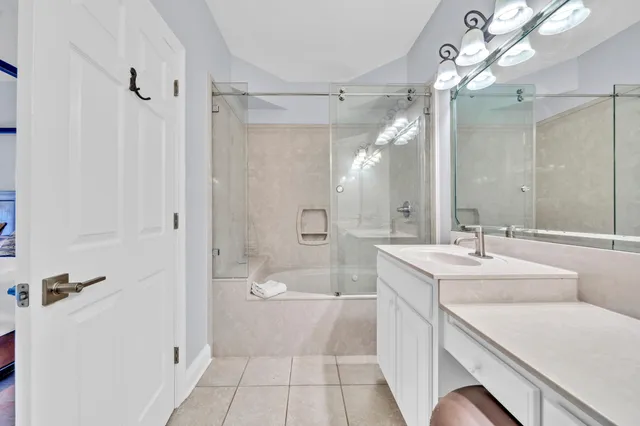 a kitchen with stainless steel appliances kitchen island a table chairs refrigerator and sink