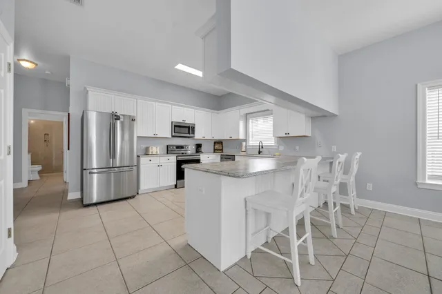 a view of a dining room with furniture and chandelier
