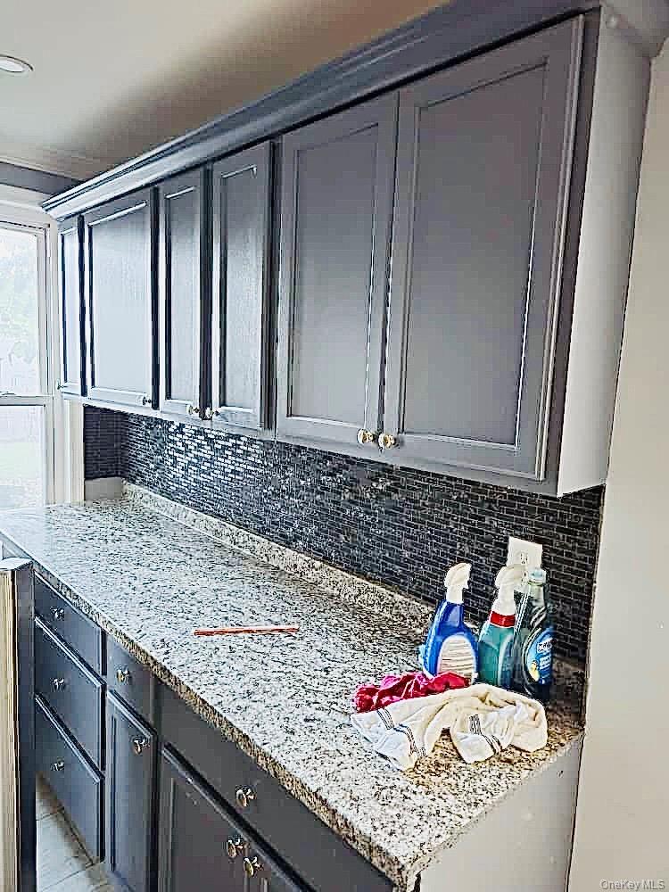 515 Summit Avenue Schenectady, NY 12307 - Photo 15 of 15 Kitchen with gray cabinetry, backsplash, and light stone countertops