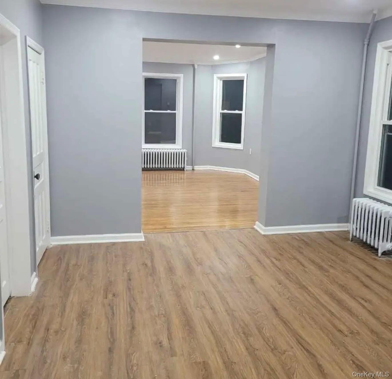 515 Summit Avenue Schenectady, NY 12307 - Photo 4 of 15 Unfurnished room featuring radiator, baseboards, wood finished floors, and recessed lighting