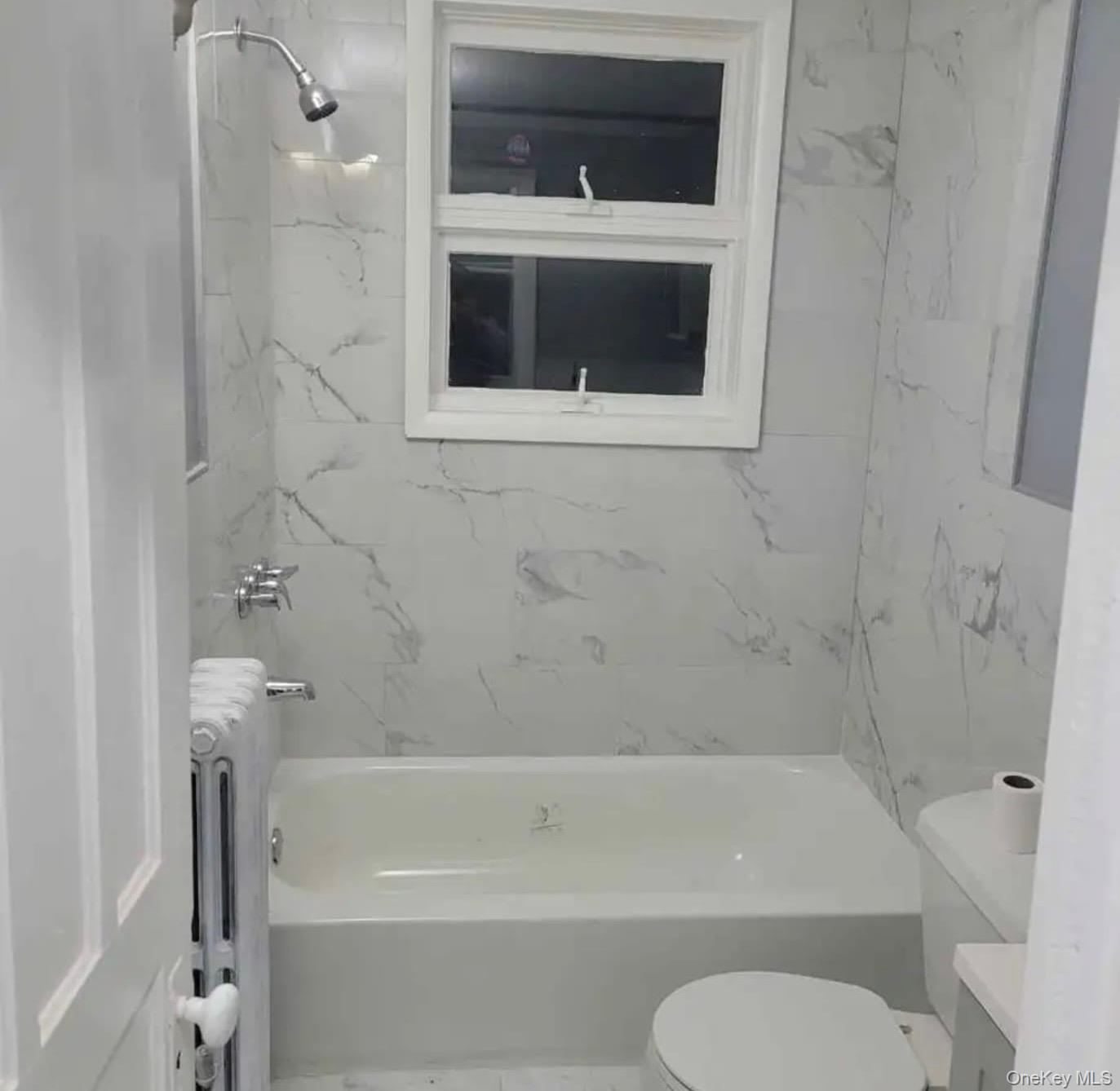515 Summit Avenue Schenectady, NY 12307 - Photo 6 of 15 Bathroom featuring toilet, vanity, and tub / shower combination