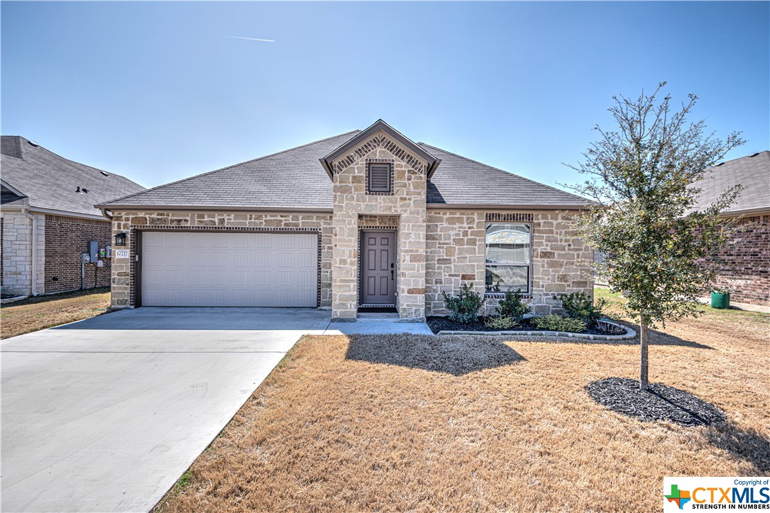 10217 Cap Rock Drive Temple, TX 76502 - Photo 1 of 1 a front view of a house with a yard and garage