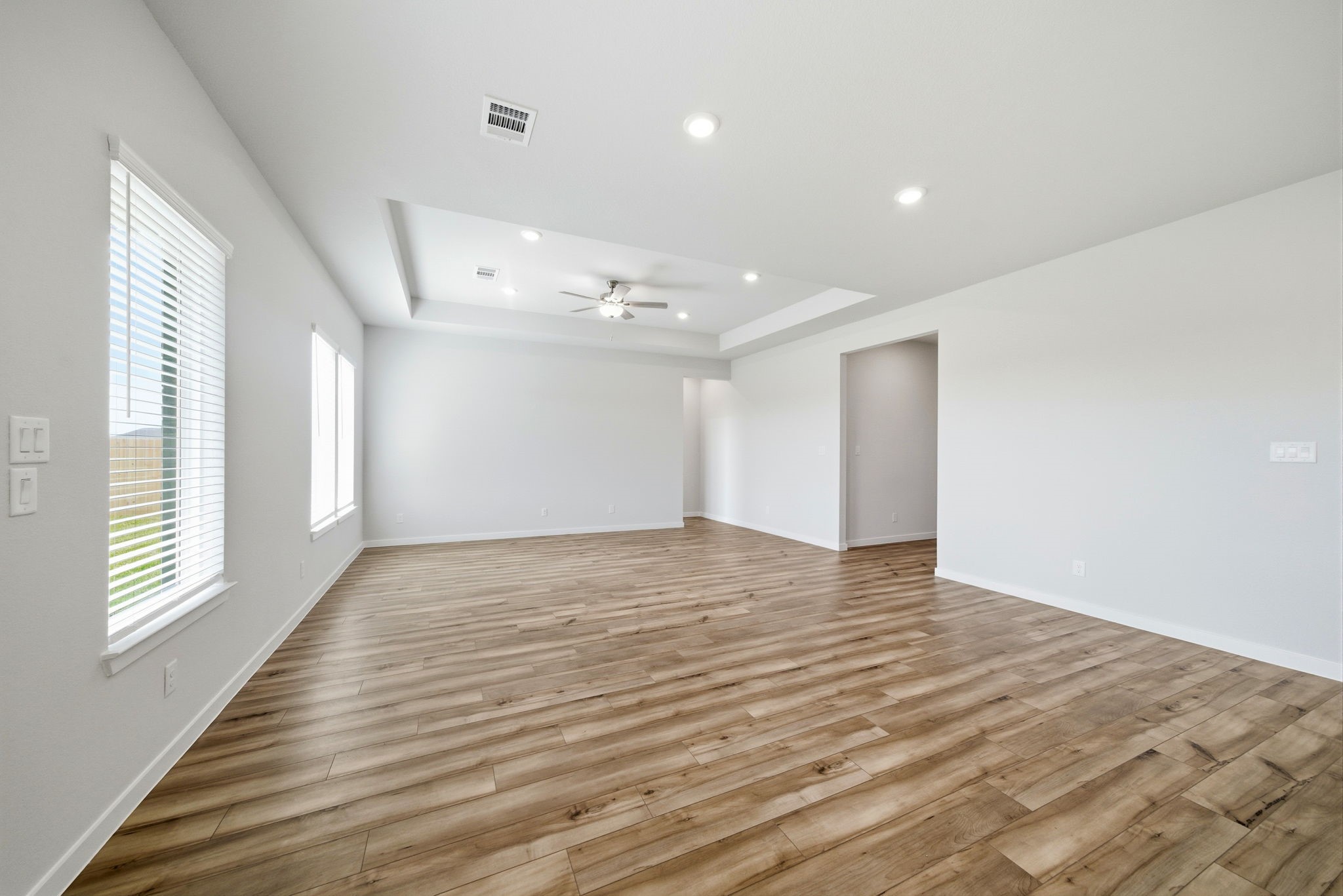1593 Elm Place Angleton, TX 77515 - Photo 13 of 31 a view of an empty room with wooden floor and a window