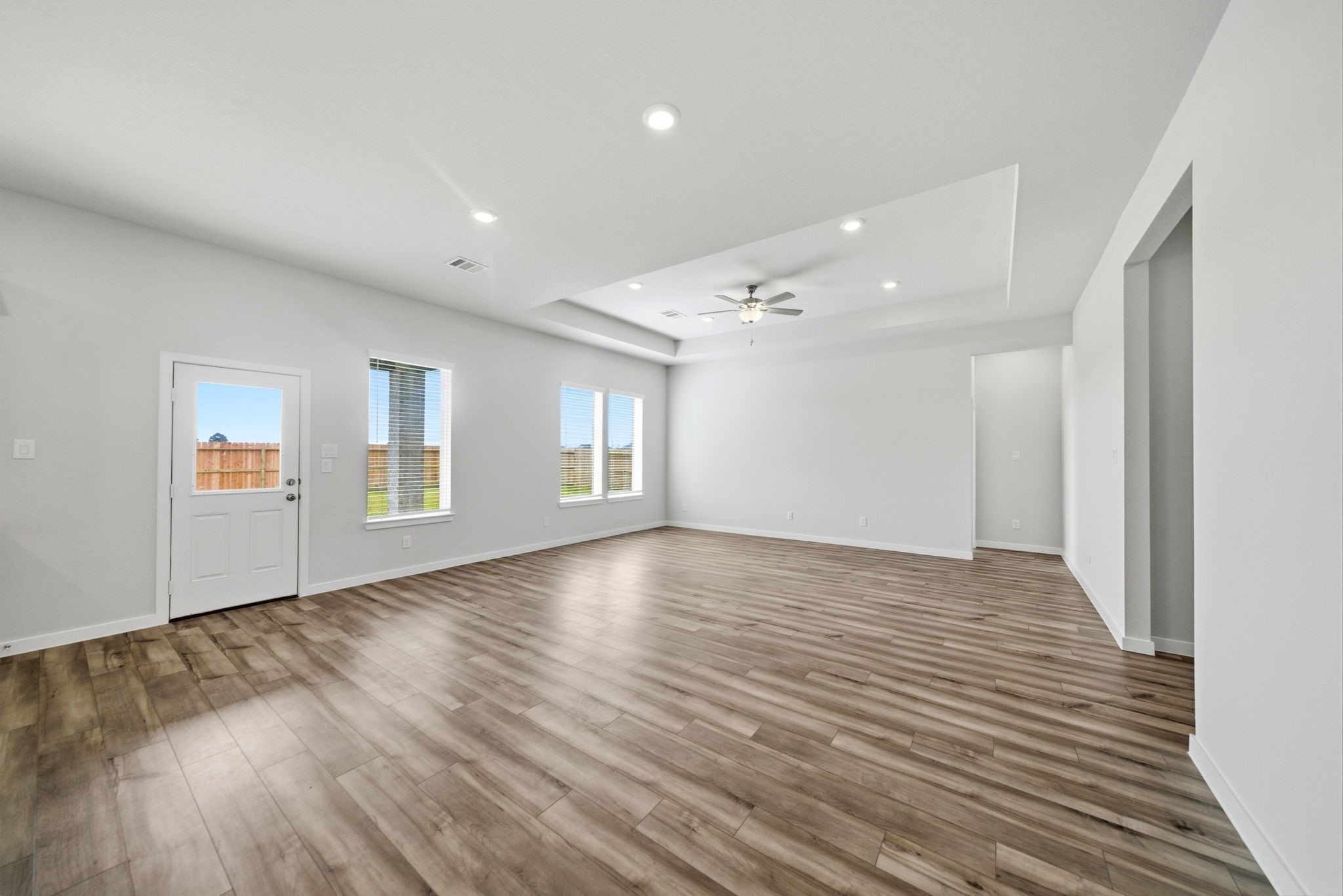 1593 Elm Place Angleton, TX 77515 - Photo 14 of 31 wooden floor in an empty room with a window