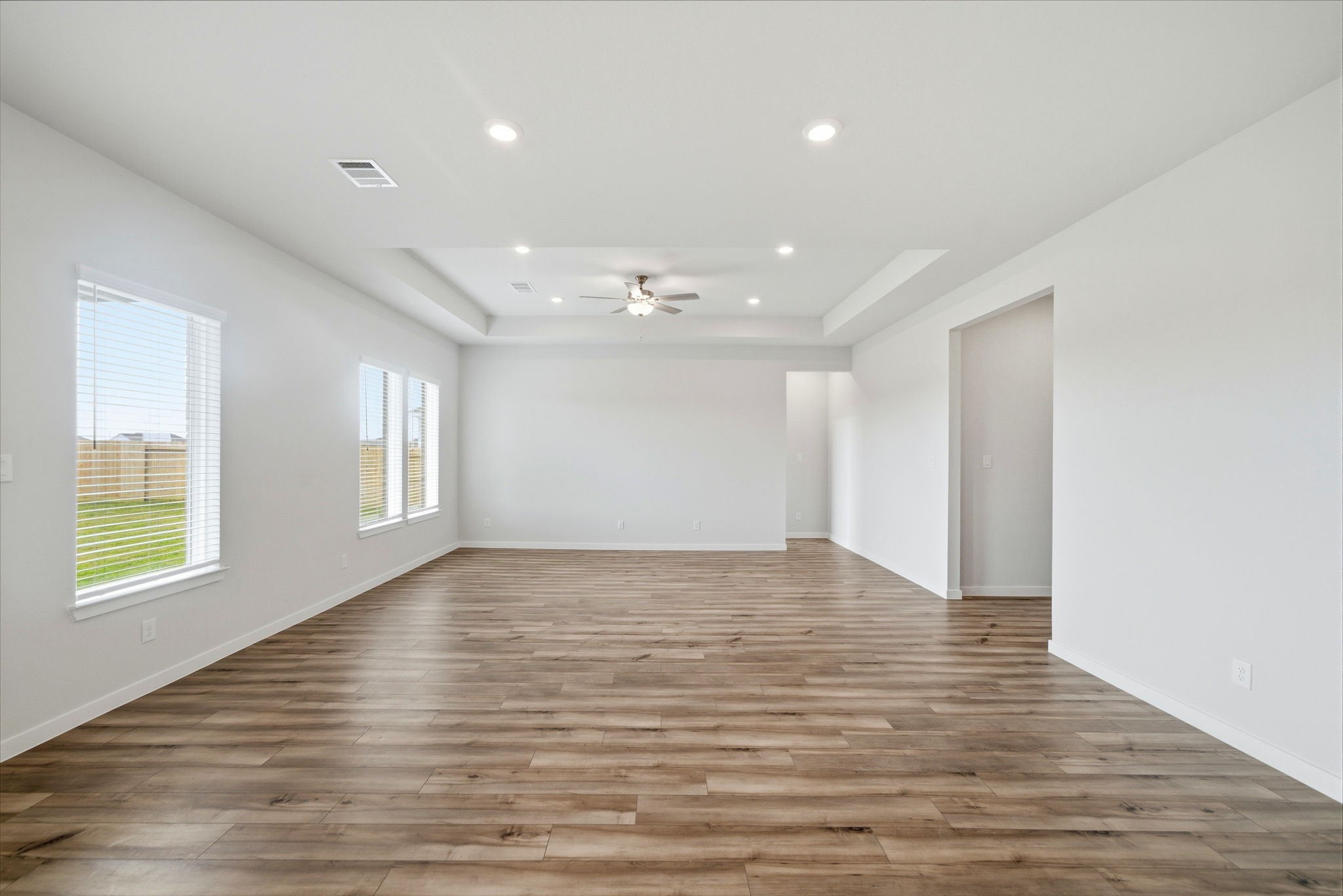 1593 Elm Place Angleton, TX 77515 - Photo 15 of 31 a view of an empty room with wooden floor and a window