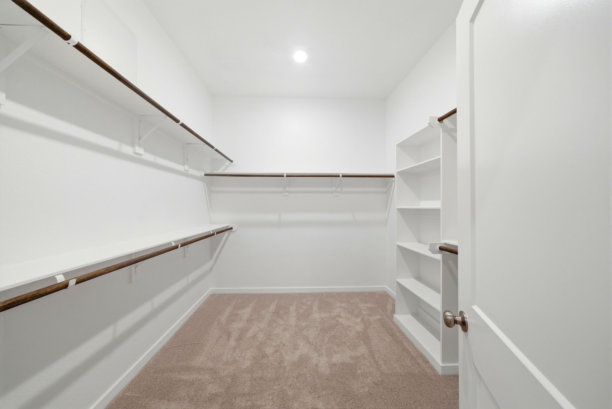 1593 Elm Place Angleton, TX 77515 - Photo 20 of 31 a view of walk in closet with empty racks