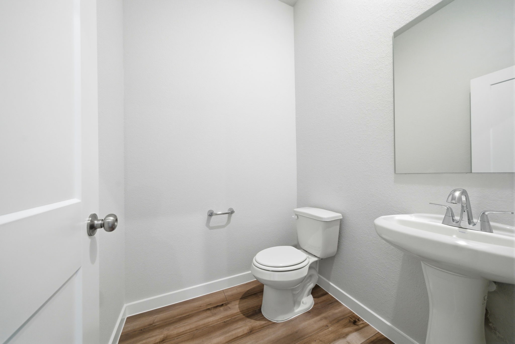 1593 Elm Place Angleton, TX 77515 - Photo 21 of 31 a white toilet sitting next to a bathroom sink