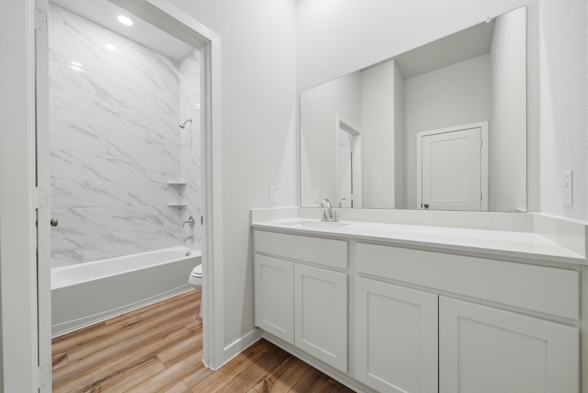 1593 Elm Place Angleton, TX 77515 - Photo 23 of 31 a bathroom with a sink and a mirror