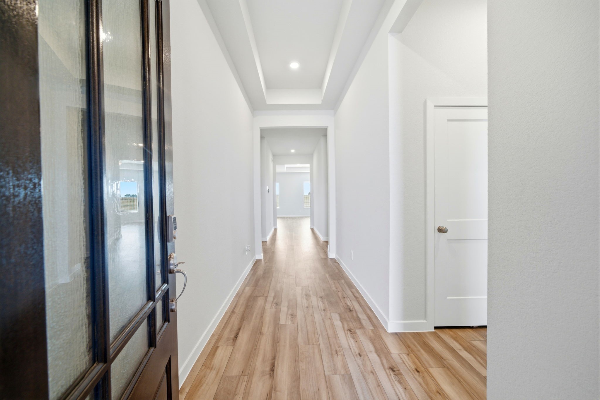 1593 Elm Place Angleton, TX 77515 - Photo 3 of 31 a view of a hallway with wooden floor