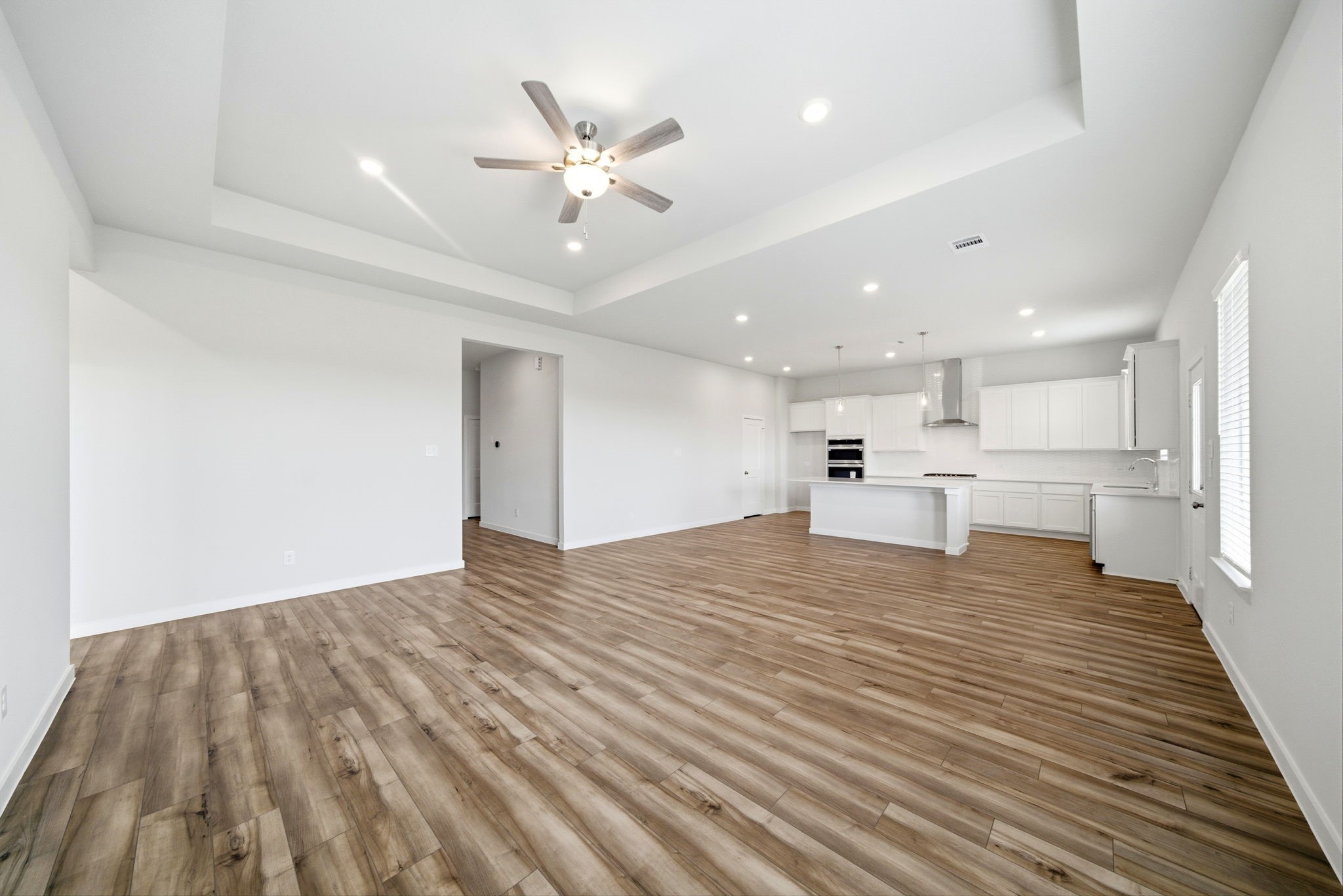 1593 Elm Place Angleton, TX 77515 - Photo 5 of 31 a view of an empty room with kitchen view and a window