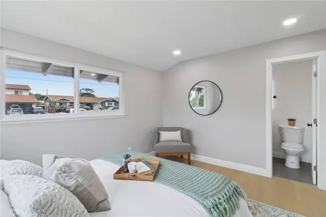 a bathroom with a sink vanity granite toilet and a mirror