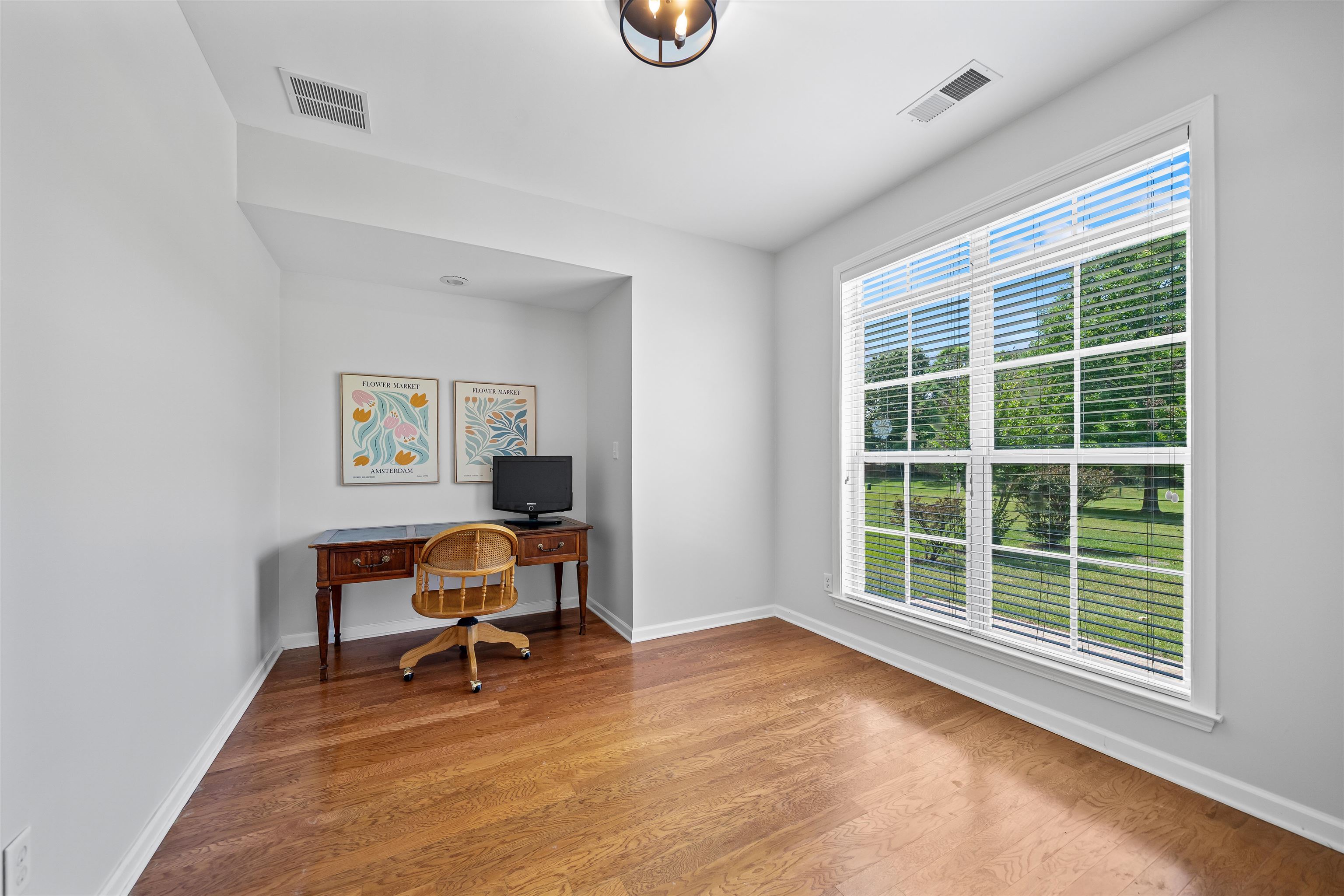 5035 Brian Ridge Road Arlington, TN 38002 - Photo 21 of 40 Bright room featuring wood-finish flooring, white walls, and a large multi-pane window with white blinds
